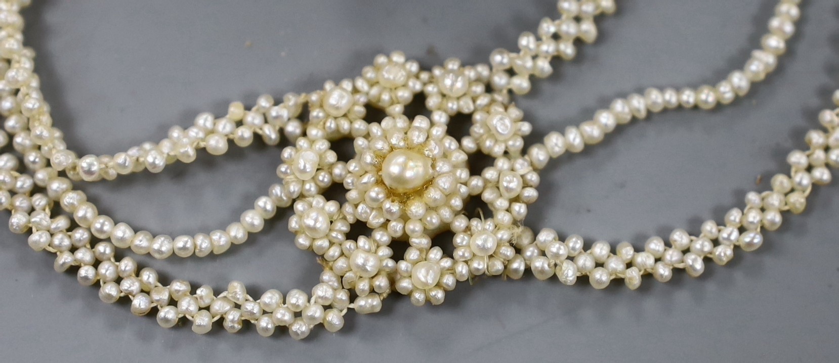 A 19th century seed pearl cluster set necklace, with yellow metal clasp, 32cm and a similar brooch.